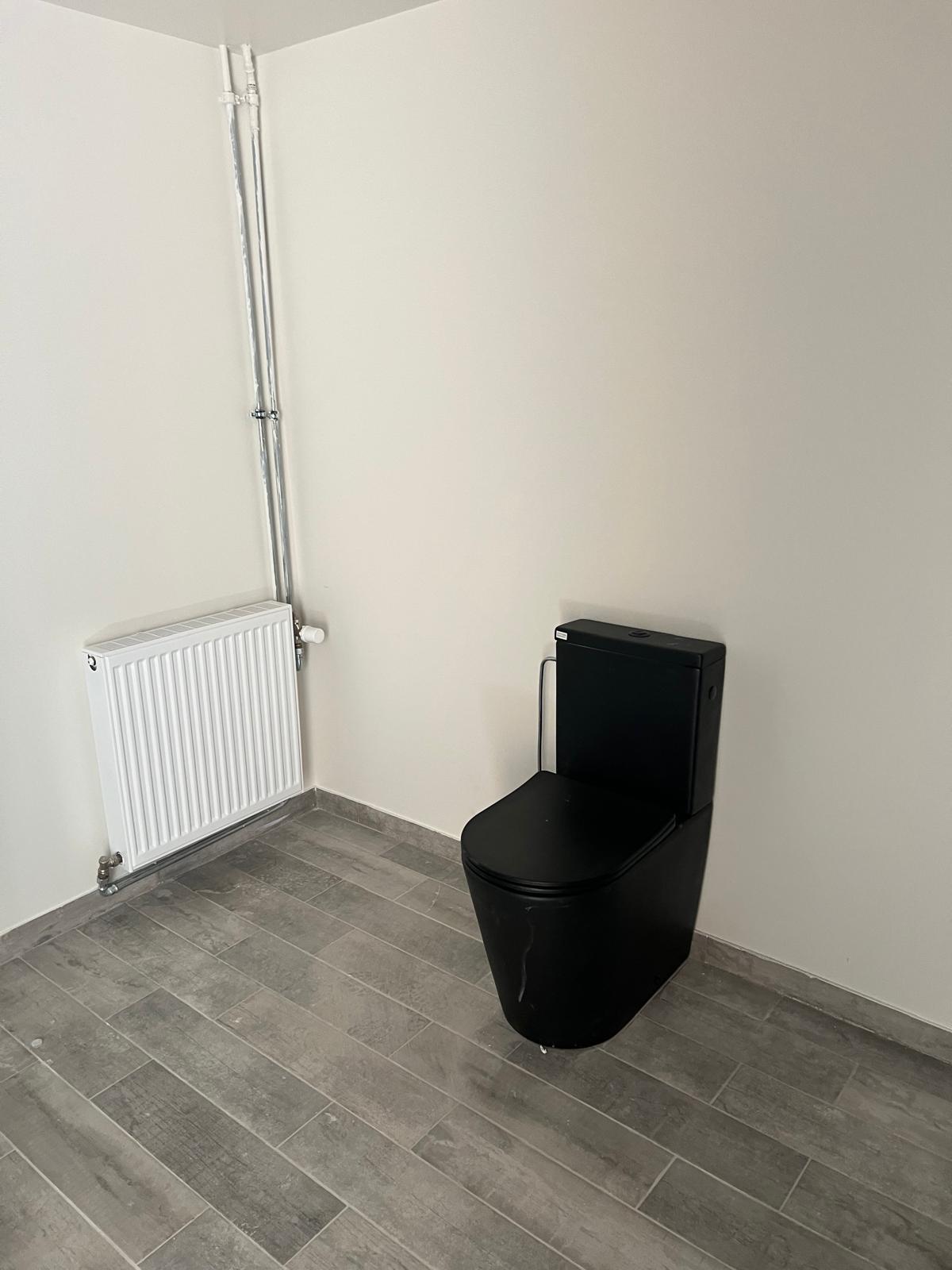 Installation WC noir au sol avec radiateur à Fleurus